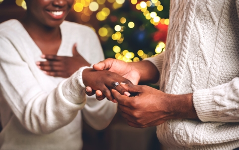 happy couple showing off engagement ring