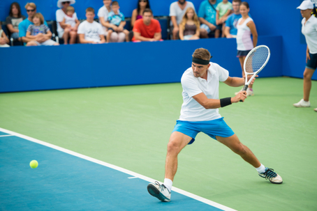 Professional male tennis player in action during a tennis match.